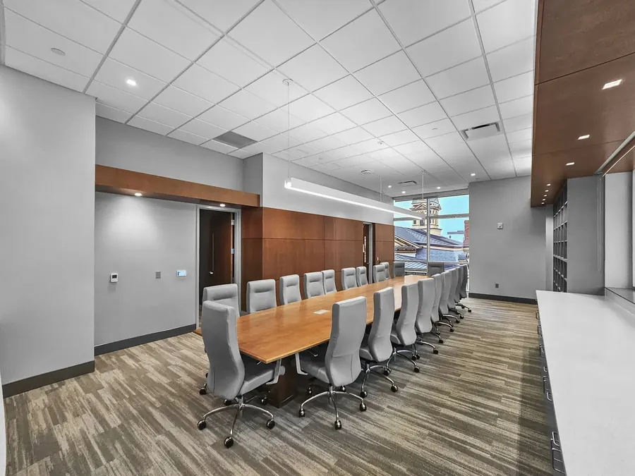 Conference room with long table and wood paneling