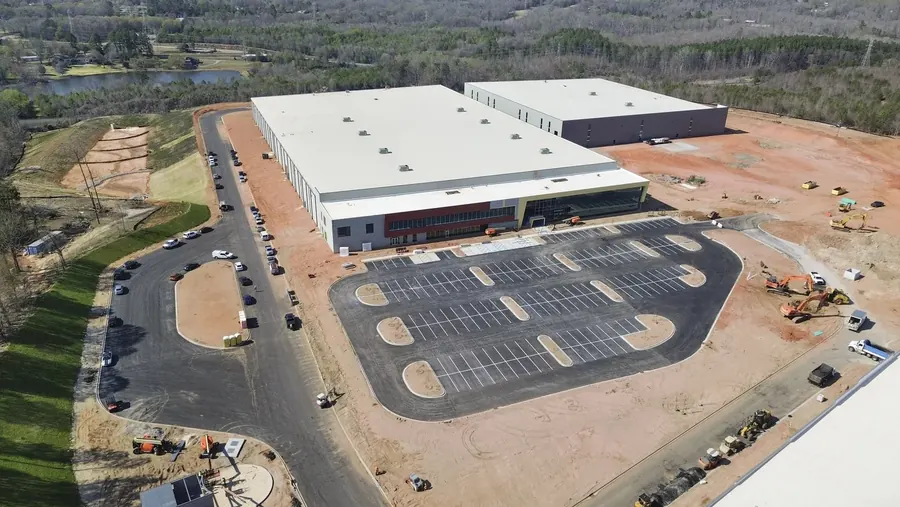 Aerial view of a large commercial building and parking area